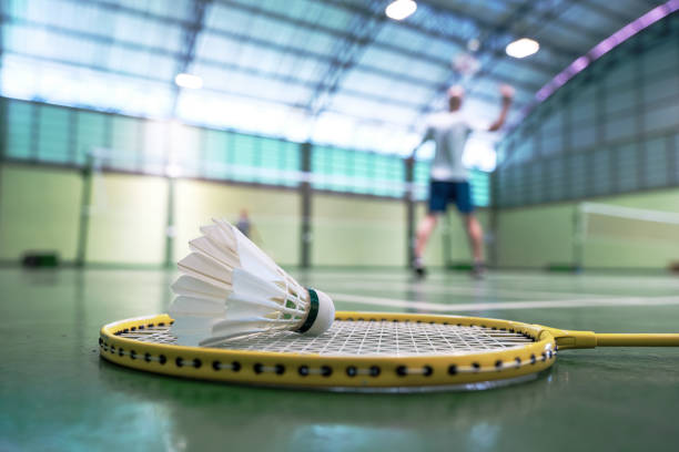 istock Close up shuttlecock on badminton racket at court 1790909441