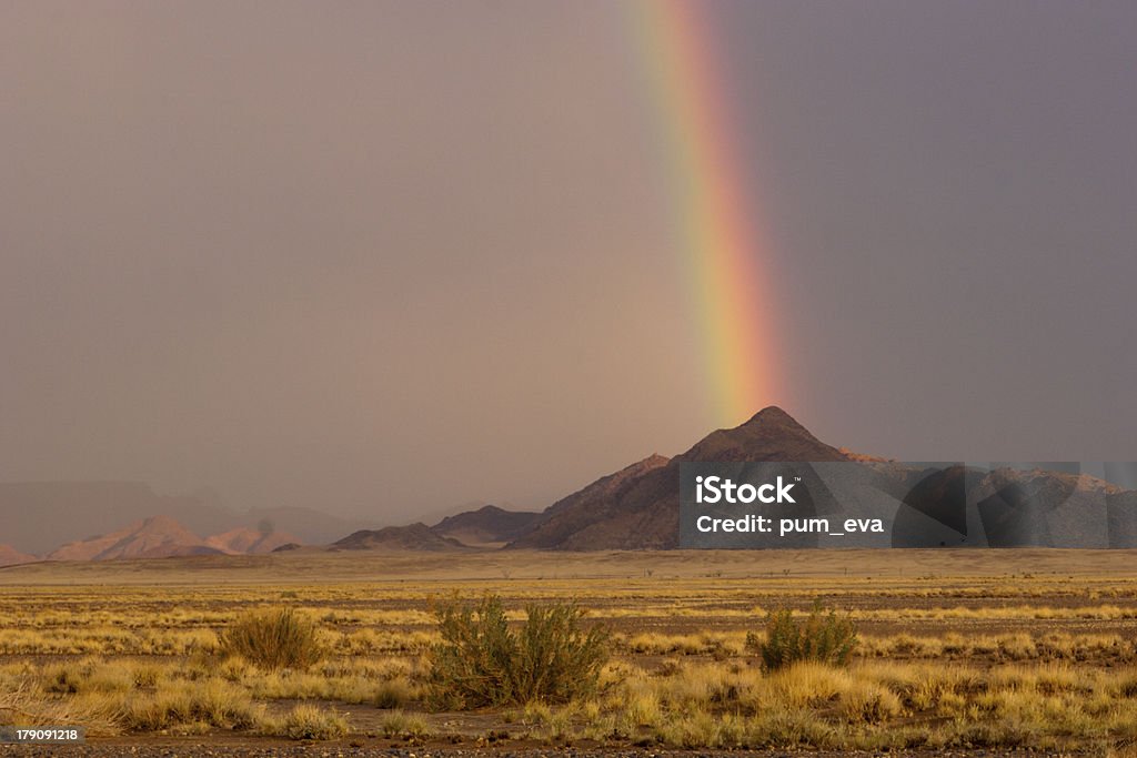 Sossusvlei, Red dunes, rainbow Red dunes and a rainbow after thunderstorm after thunderstorm in Sossusvlei. Namib desert. Namibia Desert Area Stock Photo