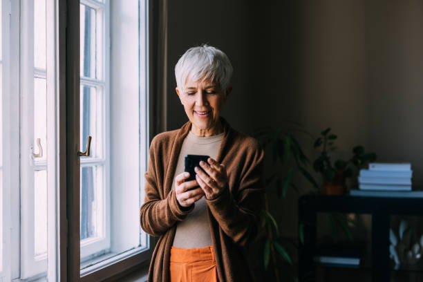 istock Connected Moments: Senior Woman Texting by the Window 1790913911