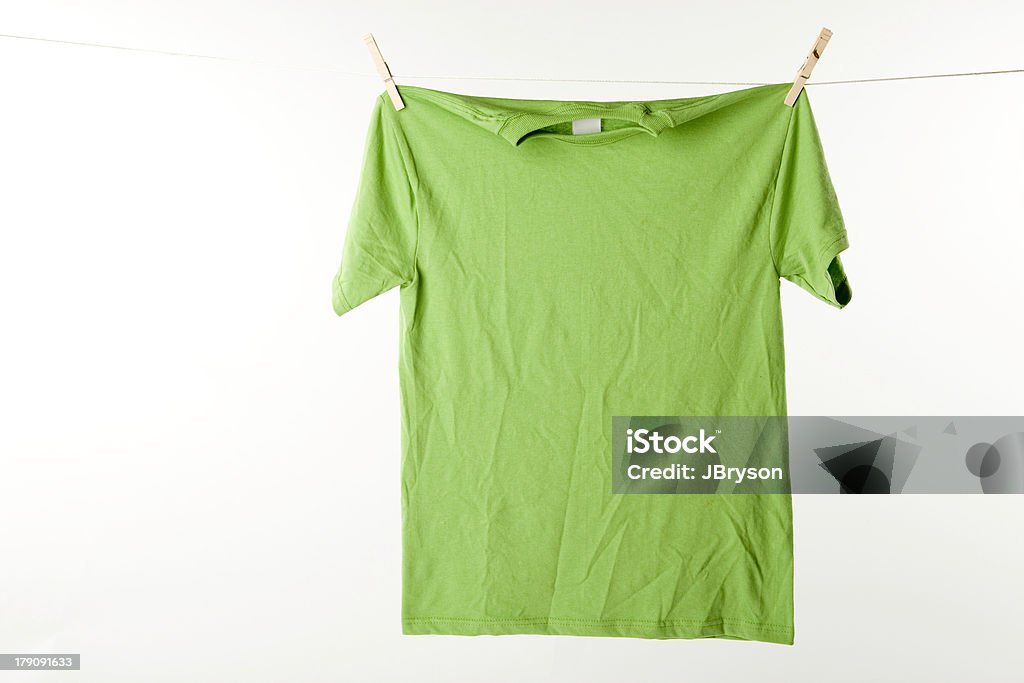 Lime Green Tshirt A bright lime green t-shirt is hanging to dry on laundry day. Clothesline Stock Photo