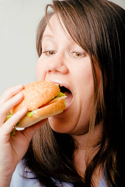 istock fat woman with hamburger 179092330