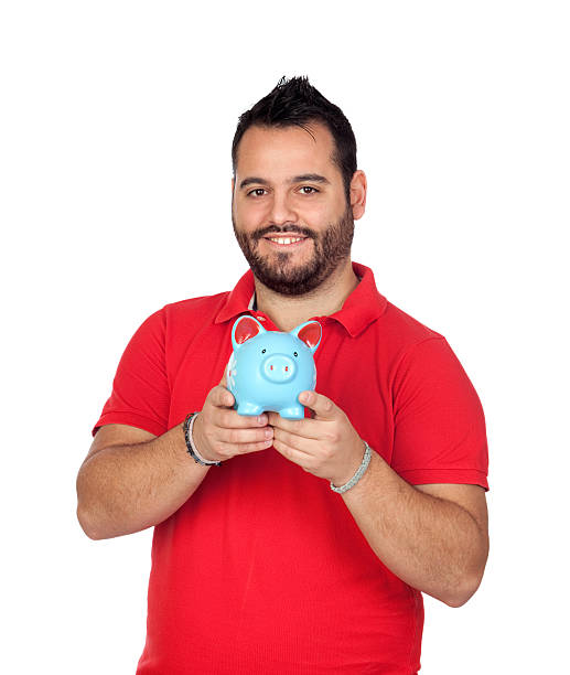 istock Bearded man holding a blue piggy bank 179092879