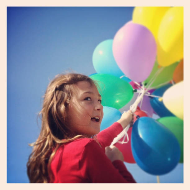 istock Girl holding balloons 179093319