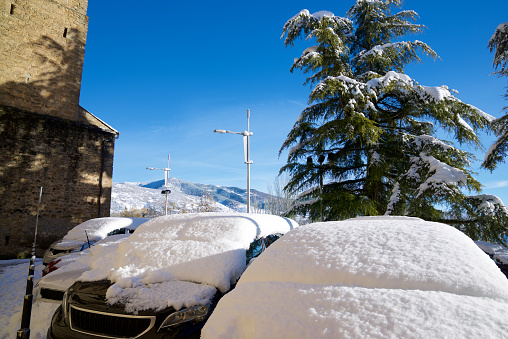 Snowy cars in Jaca, Huesca province, Pyrenees in Spain.