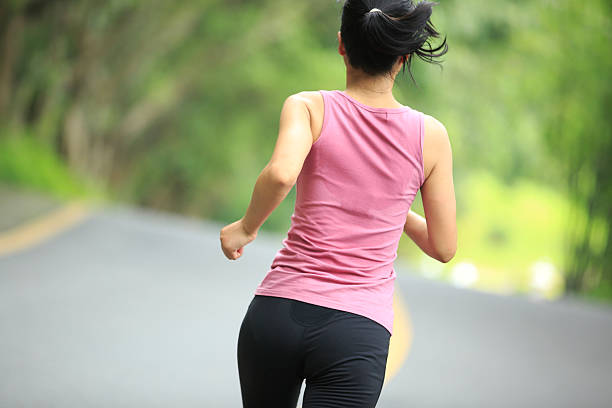 istock young asian woman running in forest 179093898