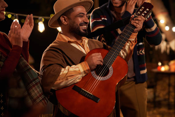 istock Happy man playing guitar at holiday 1790944438