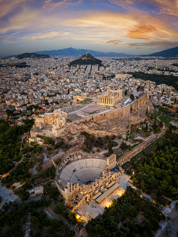 Aerial view of theskyline and ancient ruins at the Acropolis of Athens, Greece, and Odeon of Herode theatre during sunset time