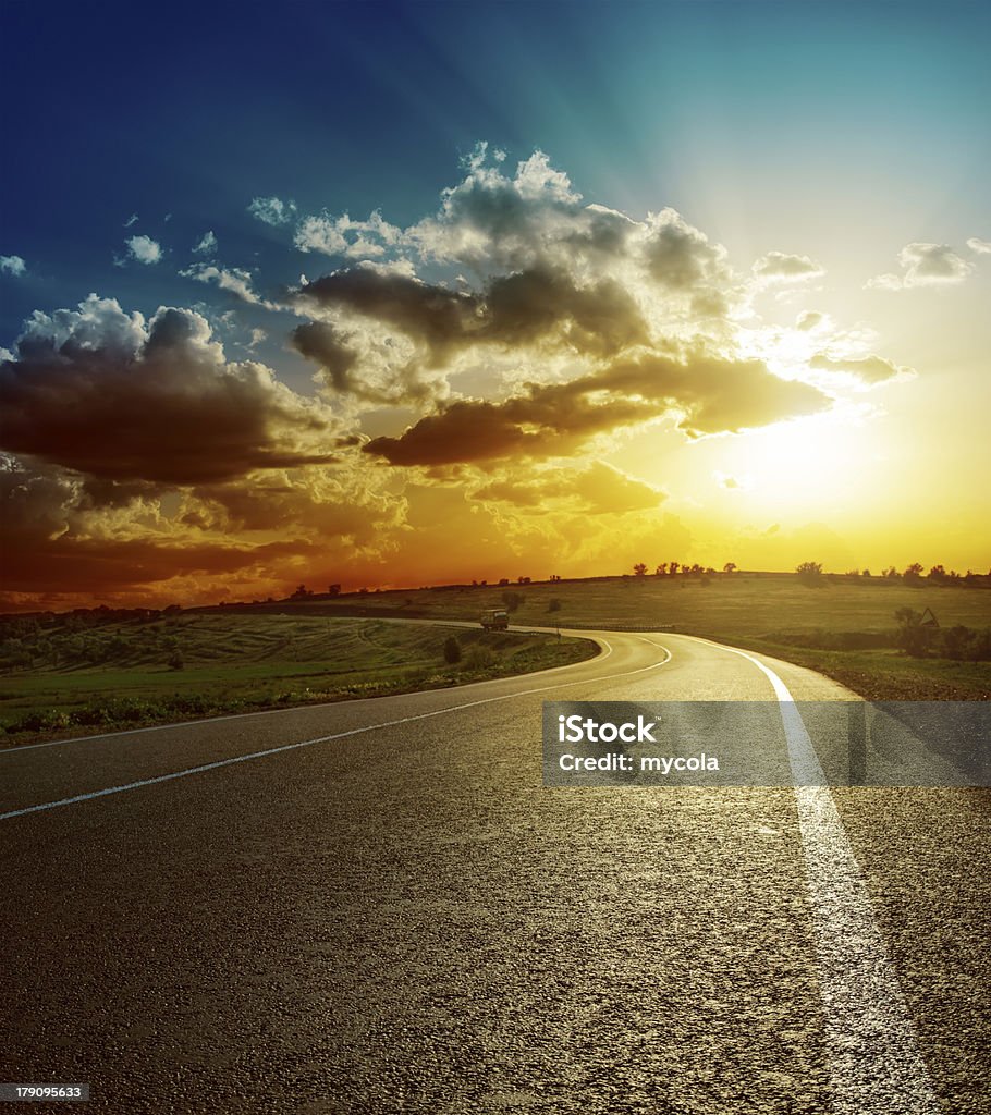 perfect sunset over asphalt road Highway Stock Photo
