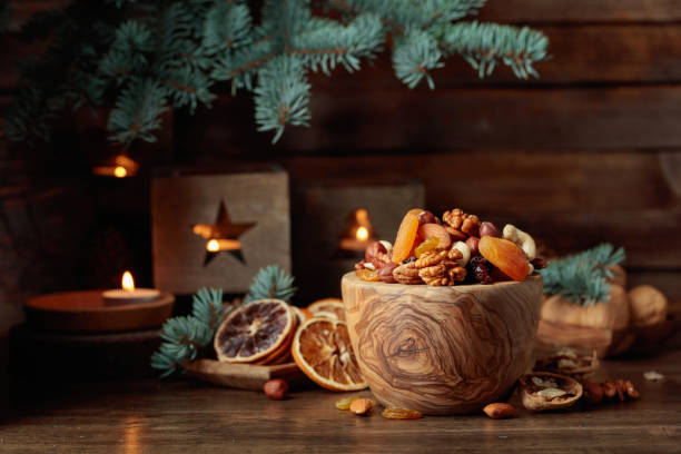 istock Dried fruits and assorted nuts on an old wooden table. 1790988619