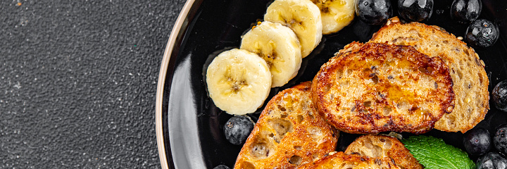 French toast sweet breakfast berries, banana pancakes fresh delicious cooking appetizer meal food snack on the table copy space food background rustic top view