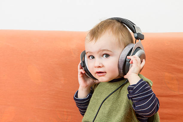 istock young child on couch with headphone 179101628