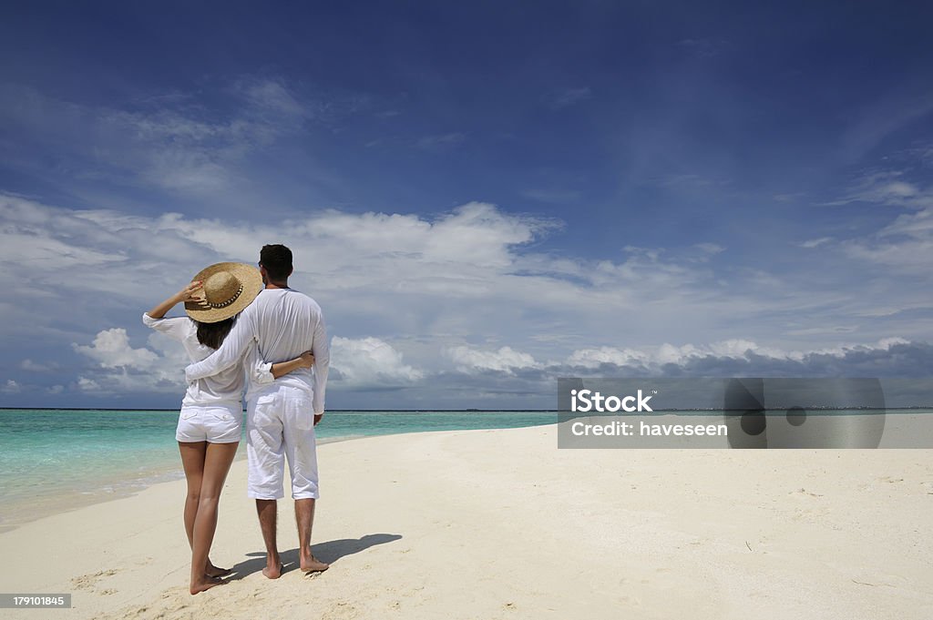 Couple on a beach at Maldives Couple on a tropical beach at Maldives Adult Stock Photo