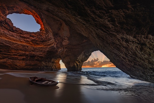 A closeup of a small fishing boat in the stunning Benagil Cave in the Algarve region of Portugal