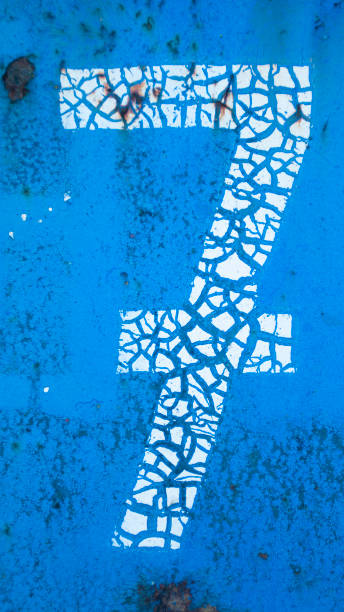 istock Cracked paint number 7 on blue metal surface 1791026629