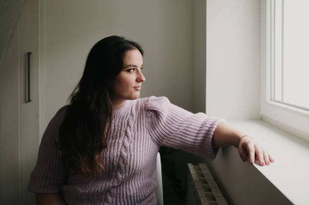 istock Woman looking out the window 1791029862