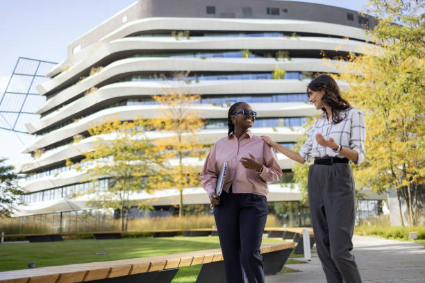 istock Happy diverse businesswomen talking while walking in the park. 1791035890