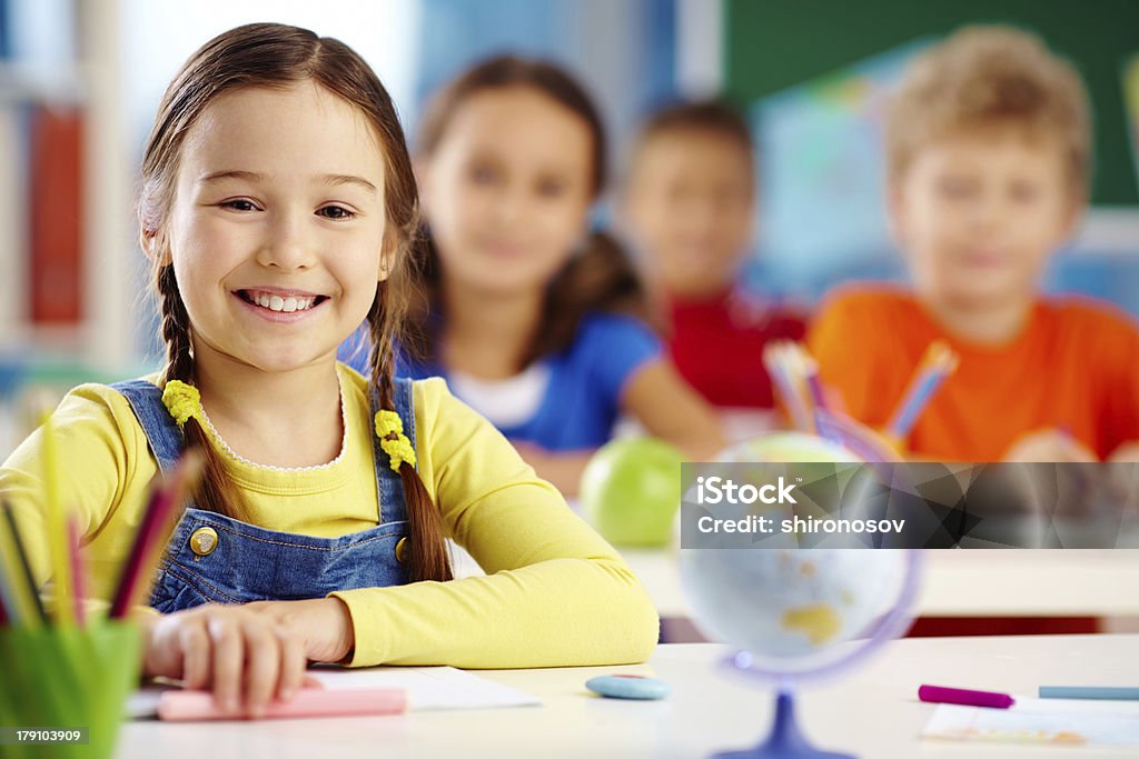 Diligent beginner Portrait of an elementary school student with a toothy smile Child Stock Photo