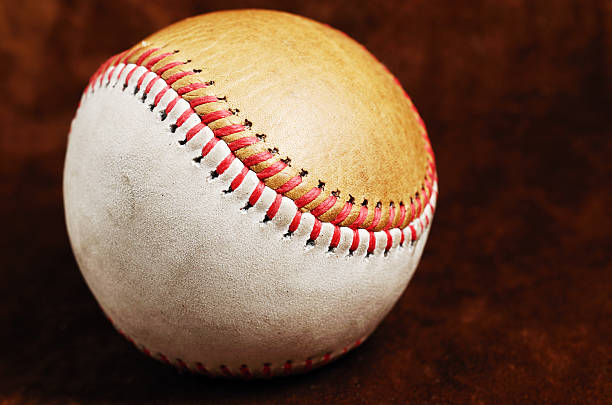 istock dirty baseball, white and brown against a dark background 179105330
