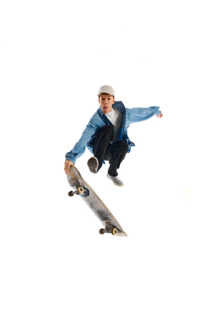 istock High jump. Active young man in casual clothes in motion, riding skateboard, training isolated over white background 1791060143