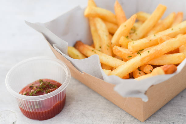istock French fries, finger chips on white table background 1791061369