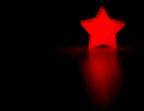 A five point star on a black background. Merry Christmas!