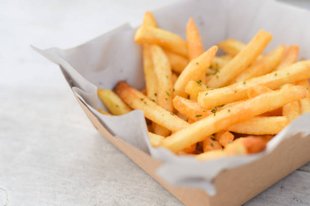 istock French fries, finger chips on white table background 1791067827