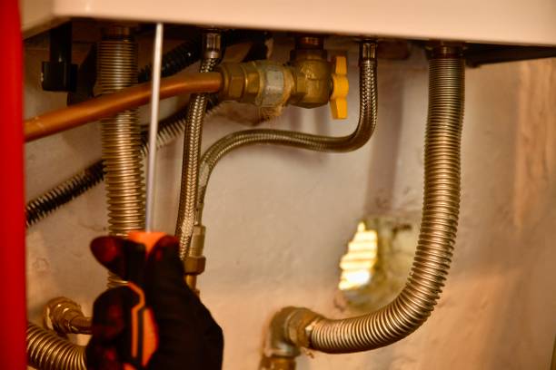 istock Technician plumber with gloves work on water boiler 1791074173