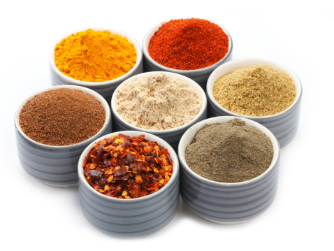 Variety of raw Authentic Indian Spice Powder on bowl. Focus on Cinnamon Powder in full-frame.