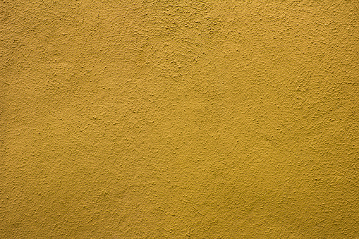 Yellow concrete wall. Copy space. Close-up.