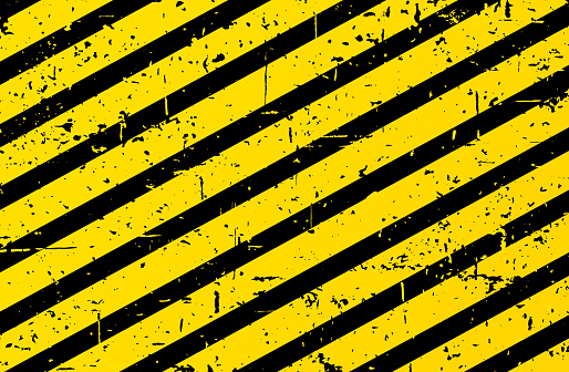 Grunge caution textured yellow black stripped background.