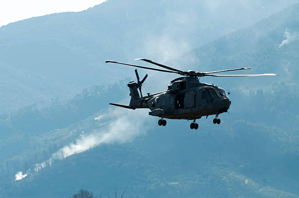istock Helicopter and smoke in the distance 179108623