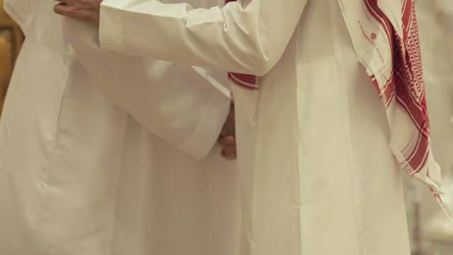 2 saudi men greeting at a wedding