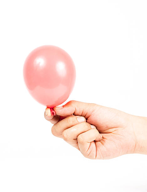 istock Hand holding colorful helium balloons 179109217
