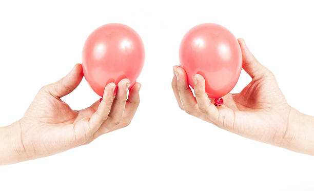 istock Hand holding colorful helium balloons 179109221