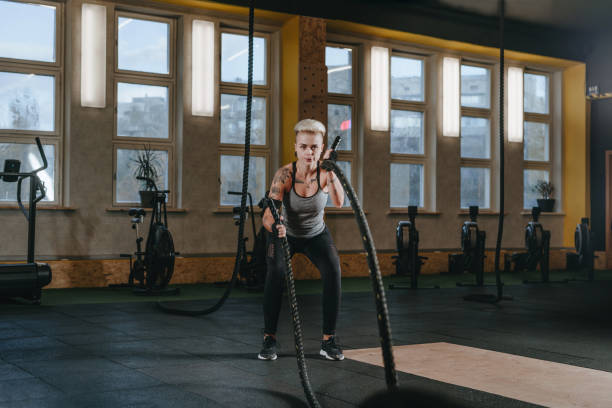 istock Athlete woman performing exercises with battle ropes 1791094862