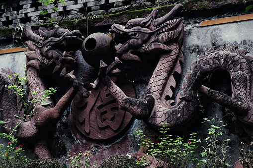 This tranquil scene captures the spirit of deep autumn at Qingyang Palace, featuring a stone dragon sculpture gracing the weathered walls of the Taoist temple. The subdued colors of fall create a serene ambiance, allowing the intricate details of the timeless dragon carving to stand out against the historical backdrop of the temple. Captured with the Leica Q3.