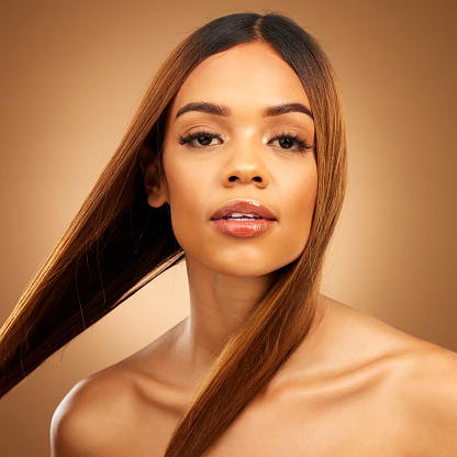 Haircare, beauty and portrait of woman in studio with strong straight hair, texture and salon shine. Happy model, healthy brunette hairstyle and natural keratin product on brown background space.