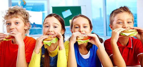 pranzo a scuola - child food school children eating foto e immagini stock