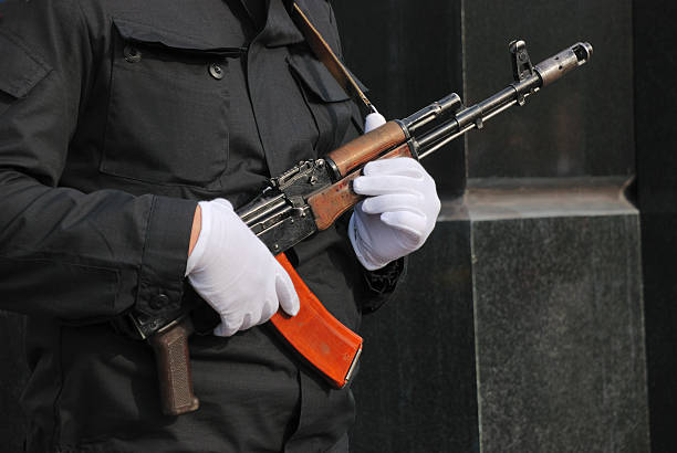 istock hands in white gloves with a rifle 179110752