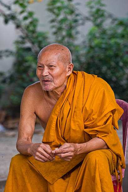 istock thai monk sits to smile 179110906