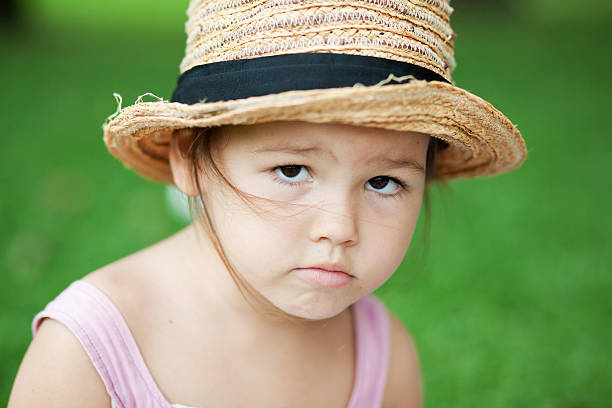 Asian Injured child in a straw hat in the park