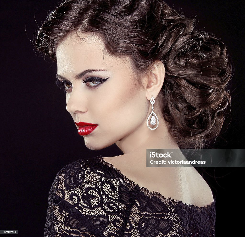 Fashion Brunette Model Portrait. Jewelry and Hairstyle. Elegant Fashion Brunette Model Portrait. Jewelry and Hairstyle. Elegant lady Isolated on black background. Adult Stock Photo