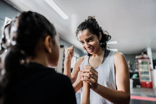 Boxe instructor greeting a child girl at gym