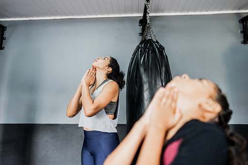 Mid adult woman stretching at boxe gym