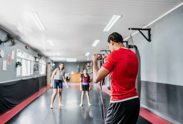 istock Instructor preparing a resistance band to do exercises at gym 1791126797