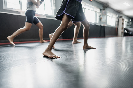 Low section of people practicing muay thai or kickboxing at gym
