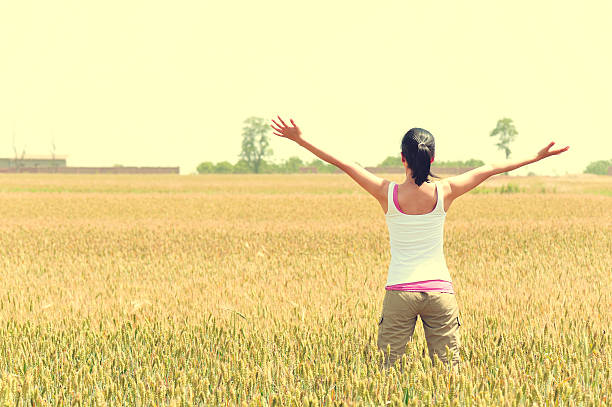 istock woman happy at wheat field 179113709