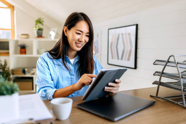 istock Young smiling beautiful woman using digital tablet at home 1791144792
