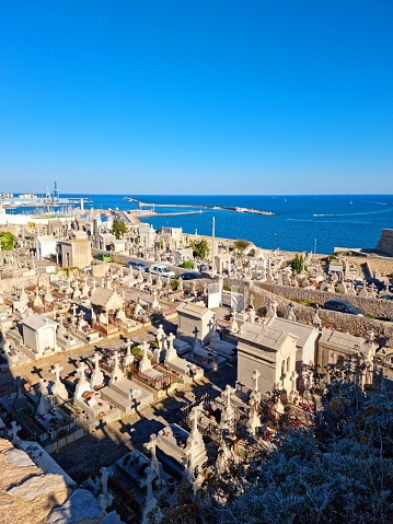 The Saint Charles Cemetery was created around the year 1680 as a burial place for the first workers who died during the construction of the Saint-Louis breakwater. The image shows several graves at the cemetery captured during autumn season.