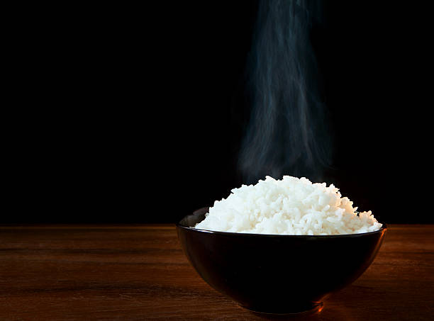 istock white steam rice in black ceramic bowl 179114624
